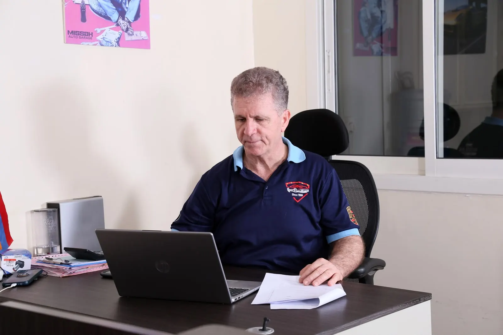 Owner of Missak Auto Garage at work in the Mussafah office