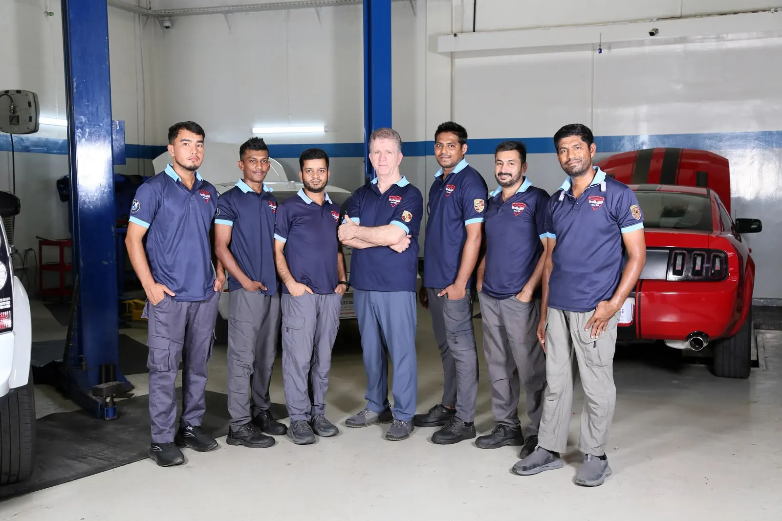 Missak Auto Garage technicians inspecting a Porsche engine in the Abu Dhabi workshop